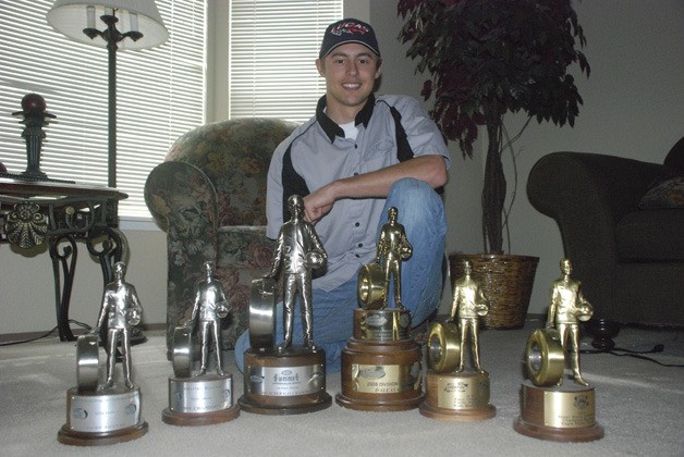 Dallas Glenn of Covington with his collection of drag racing trophies at his parents’ home in April 2011. Glenn landed a new job with the crew of pro stock drivers Jason Line and Greg Anderson.
