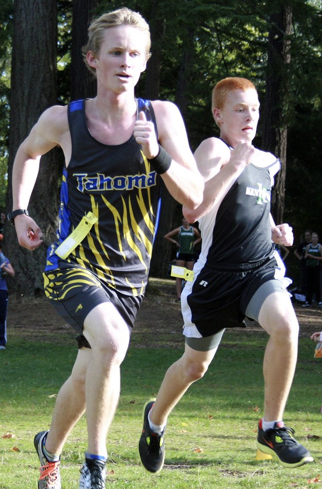 Tahoma High senior Riley Caler races shoulder to shoulder with a Kentwood student in the junior varsity race Sept. 28 at Lake Wilderness Park.