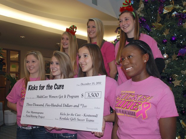Members of Kentwood’s 2011 girls soccer team present a check to the MultiCare Mammogram Assistance Program at the Covington location in December 2011.