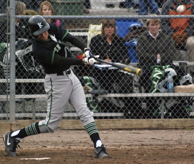 Kentwood's Jordan Jones makes contact with the ball on the team's way to a 7-2 win over Auburn on April 9.