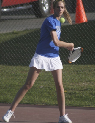Kelly Lehigh uses her backhand stroke to return a shot from Kentwood's Tess Manthou Friday in a singles match at Tahoma.