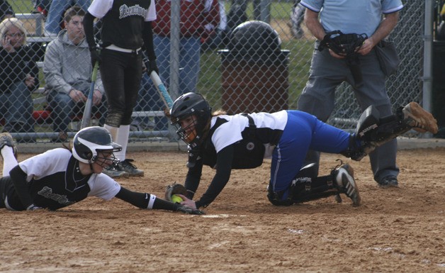 Kentwood's Allison Newcomb is called out at the plate in the game against Bothell Saturday at Kentwood High.