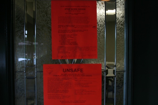 The city's stop work order and unsafe notices on the entrance to Green Society Group in Maple Valley.