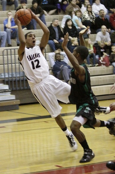 Kentlake's Daniel Landram tries to get a shot off as he falls out of bounds against Kentwood