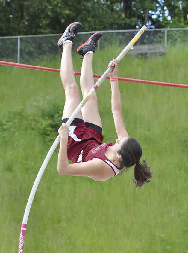 Kentlake's Lizzy Reichlinger vaults herself into the air at the West Central District track and field meet at French Field in Kent over the weekend. Reichlinger finished 5th in the women's pole vault event.