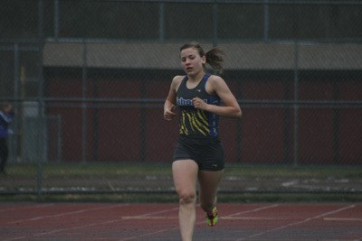 Tahoma junior Elizabeth Oosterhout leads the pack in the two mile. She took first place with a time of 11:35.59.