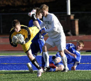 Kentwood goalie Mitch Pombrio (left) makes a save against Tahoma during the first half.