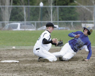 Kentwood second baseman Travis Long (left) tries to block Tahoma’s Kyle Conwell from stealing second base during the third inning of Tuesday’s game. Conwell was safe on the play and scored moments later on a double by Zach Aaker.