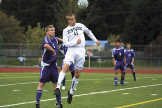 Kentwood’s Conner Biggs goes high for a header in front of Tahoma’s Tyson Ellis during Saturday’s West Central playoff game at Bethel High.