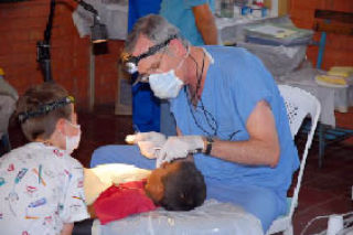 Dr. Richard Quinn removes a Nicaraguan boy’s tooth with the help of Ben Lewis. The men are from Maple Valley.