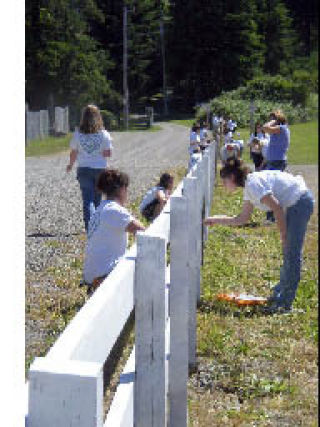 Painting fences was one of the community service tasks for participants in an LDS church youth conference last month.