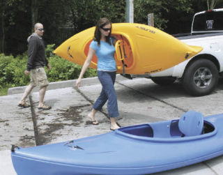 Kayakers such as Elizabeth Kennedy and Todd Glenn of Des Moines won’t have to pay a launch fee if they don’t use the boat ramp at Lake Meridian. But unless it’s light watercraft that can be launched from the beach