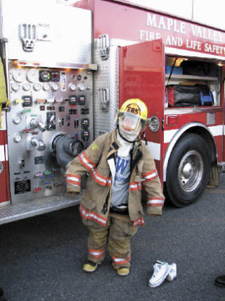 One of the kids at last year’s community event sponsored by Cedarcreek Covenant Church temporarily traded his sneakers for the boots and other gear of a firefighter.