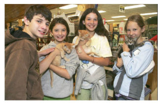 A cat adoption event in the Covington-Maple Valley area last Saturday attracted Jacqueline Gillis (second from right)