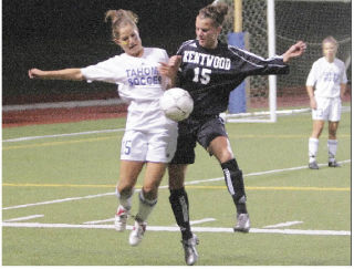 Tahoma’s Riley Sanders (left) battles for the ball with Kentwood’s Chelsi Pennington. Kentwood turned back Tahoma last Thursday night