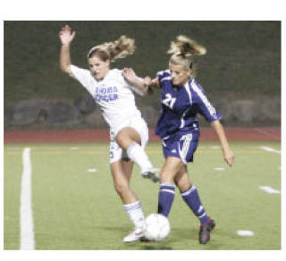 Tahoma’s Tarah Duty (left) and Auburn Riverside’s Cheyenne Gautney battle for the ball during Tuesday night’s game at Maxwell Stadium.