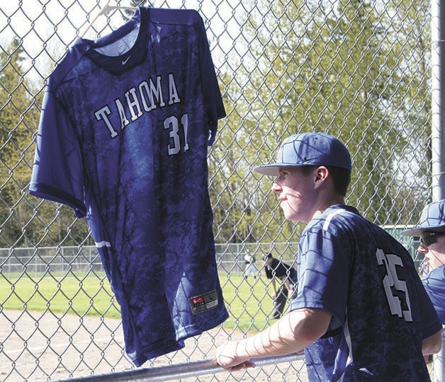 Connor Johnson’s No. 31 jersey hangs in the Tahoma baseball team’s dugout  during an away game on April 7 against Kentridge. Johnson died in a car accident Feb. 15.