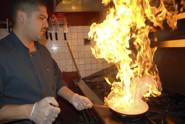 Gino Rivera works in the kitchen of his Federal Way restaurant