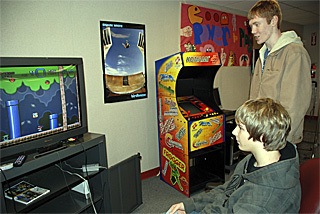 Eric Johnson plays one of the popular “Mario” titles on the Super Nintendo in the game room at The Den