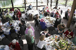 Tables set by volunteer hostesses were filled for the event.