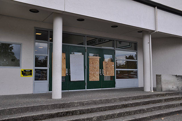 The entrance to the Kentwood High School Performing Arts Center was boarded up on Friday after two men allegedly vandalized the school overnight. HEIDI SANDERS, Kent Reporter