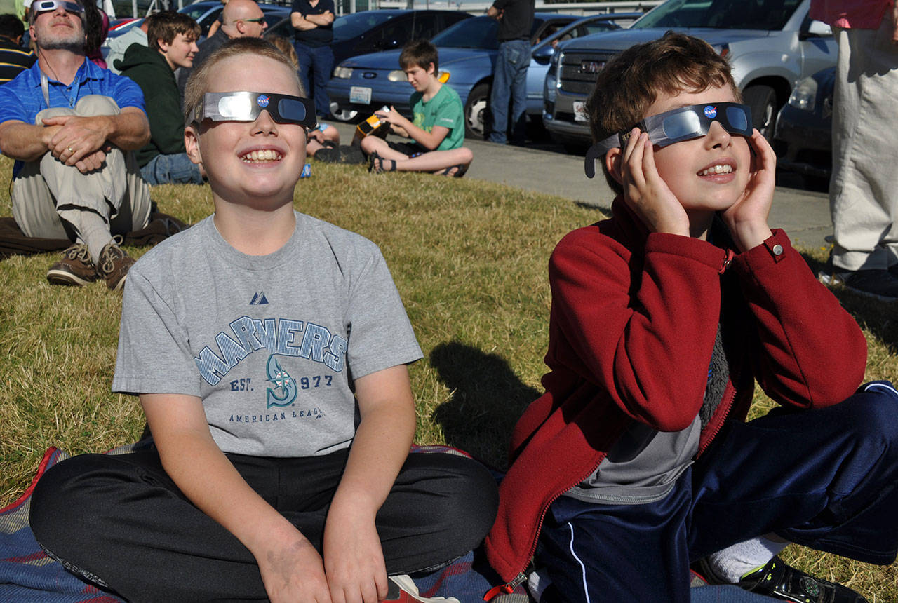 Jay Murison, 11, left, and his brother, Mason, 9, show off their eclipse viewing glasses. HEIDI SANDERS, Reporter