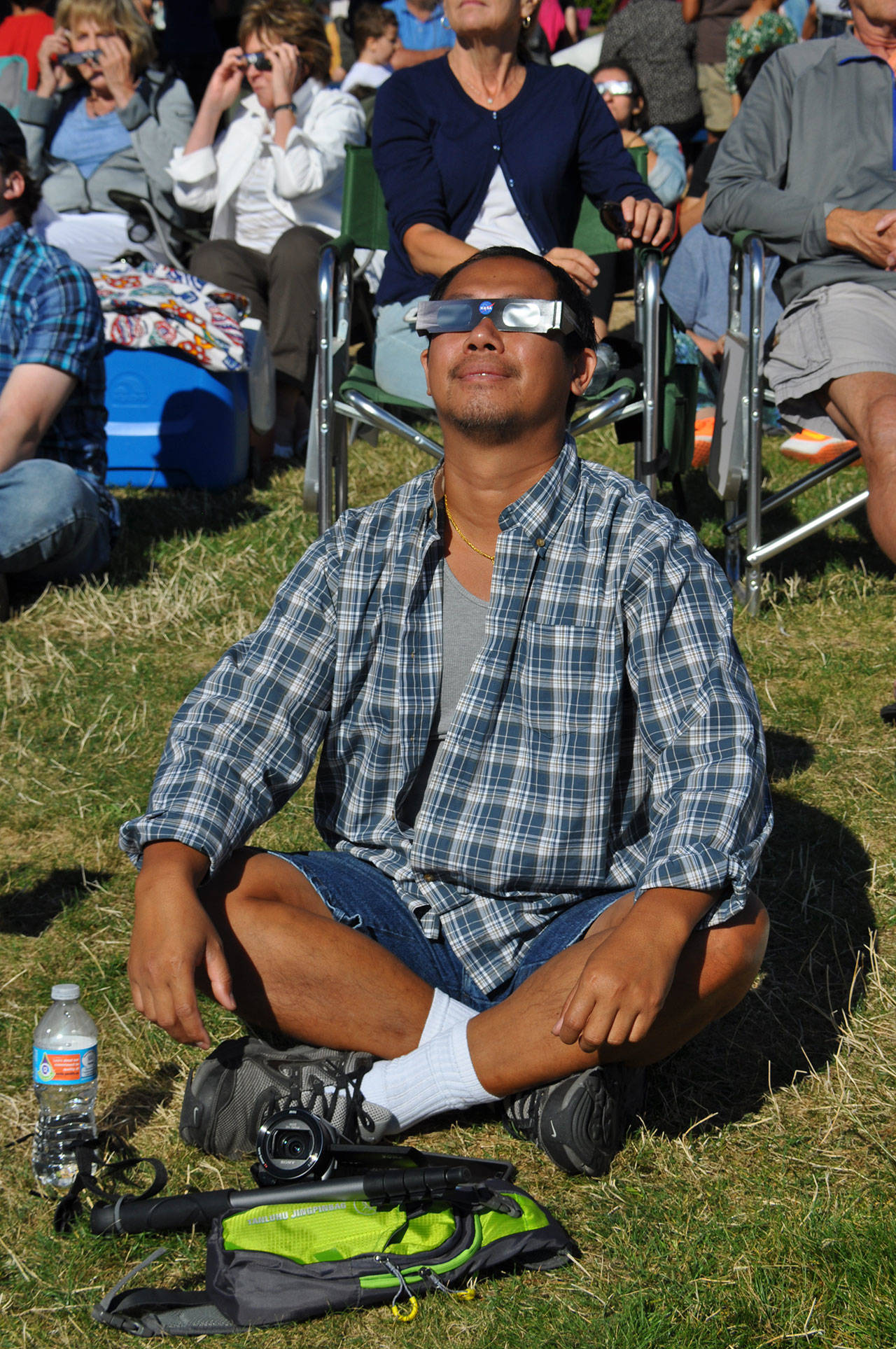 Tiger Keo, of Renton, looks at the eclipse. HEIDI SANDERS, Reporter