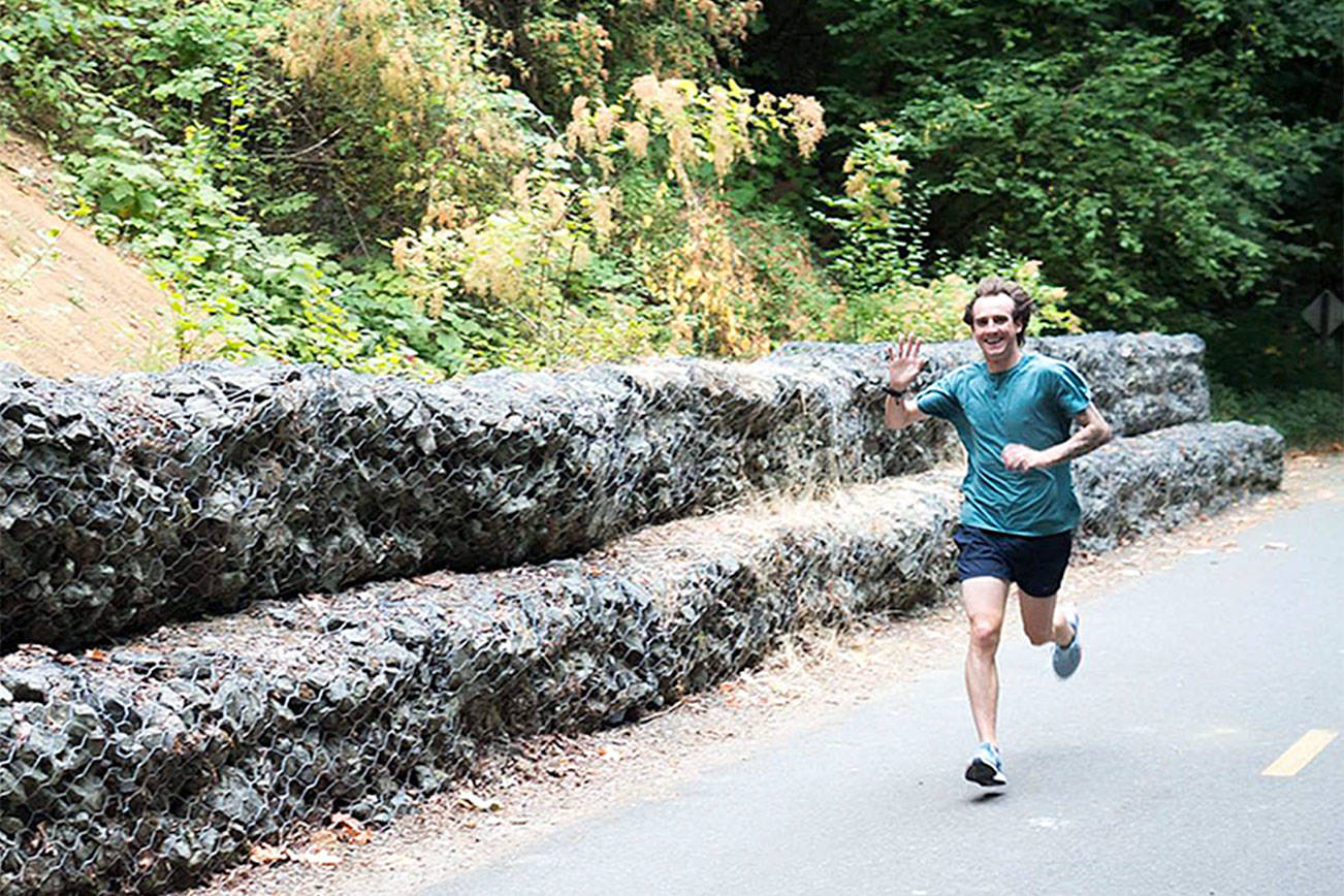 A runner waves while he goes by during the first Renton parkrun trial on Aug. 12. Courtesy photo