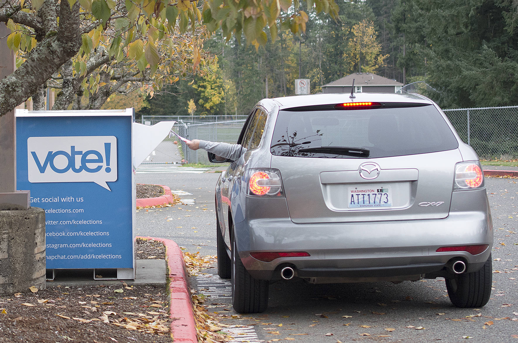 A voter drops of their ballot at a drop off box in Maple Valley for the November 2017 election. File photo by Kayse Angel