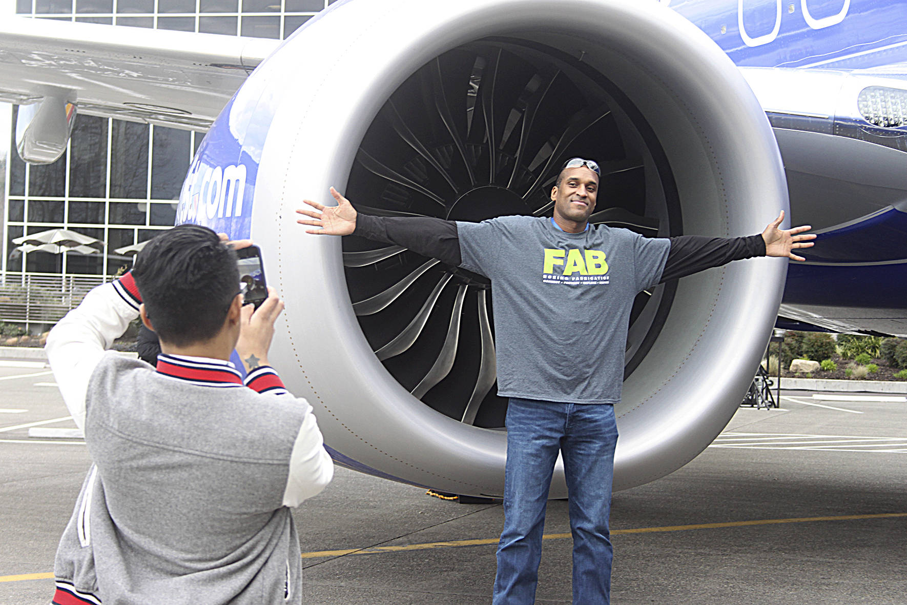 Ahron Goins, supply chain analyst at Boeing, poses in front of the 10,000th 737 airplane. Leah Abraham, Renton Reporter