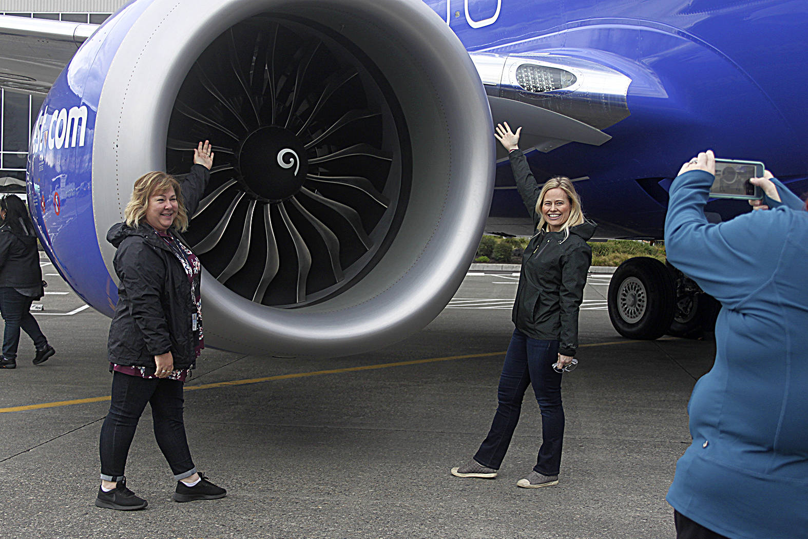 Kim Burton, left, and Denise Caldwell, right, pose in front of the 10,000th 737 airplane. Leah Abraham, Renton Reporter