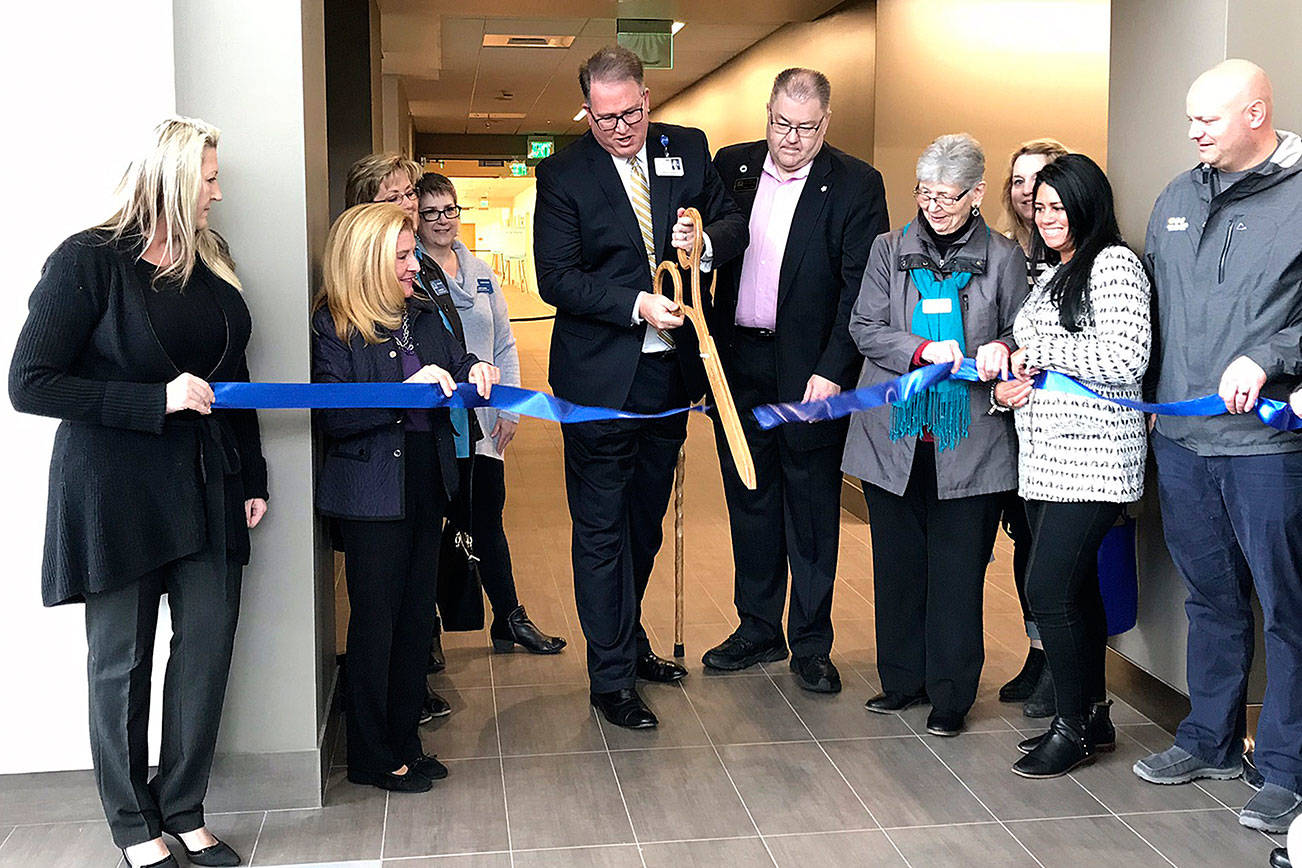 Mark Smith, the president and chief operating officer for Auburn and Covington MultiCare, cuts the ribbon for the new MultiCare facility in Covington on April 7. Photo by Kayse Angel