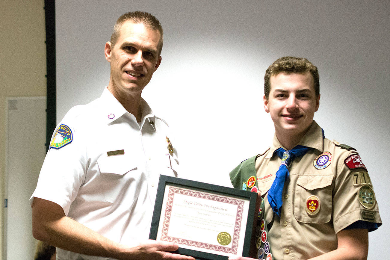 Maple Valley Fire Chief Aaron Tyerman presented Kyle Sommer, a Boy Scouts of America Eagle Scout to be, a Certificate of Appreciation Award during the Commissioners Meeting at Station 81 in Maple Valley on April 12. Photo by Kayse Angel