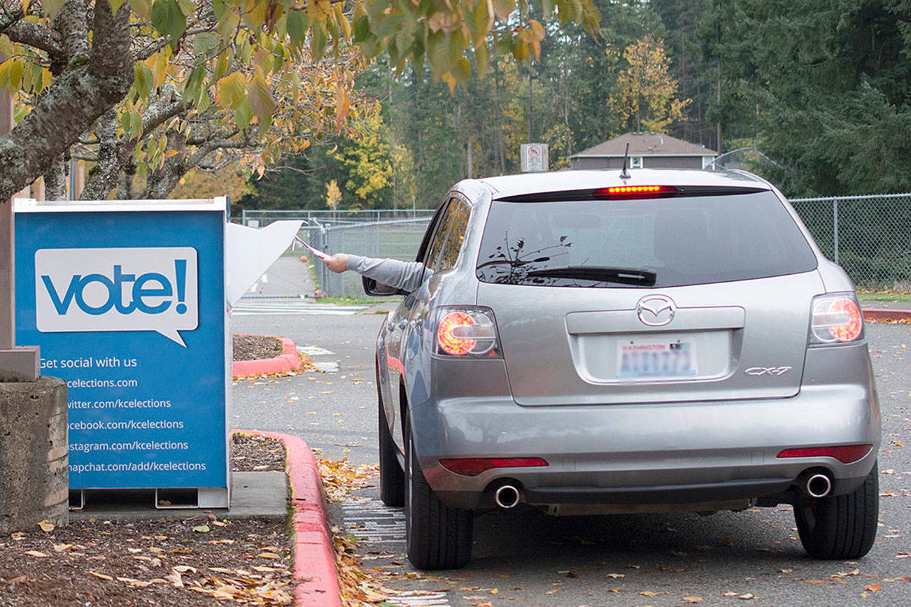 A voter drops of their ballot at a drop off box in Maple Valley for the November 2017 election. File photo by Kayse Angel