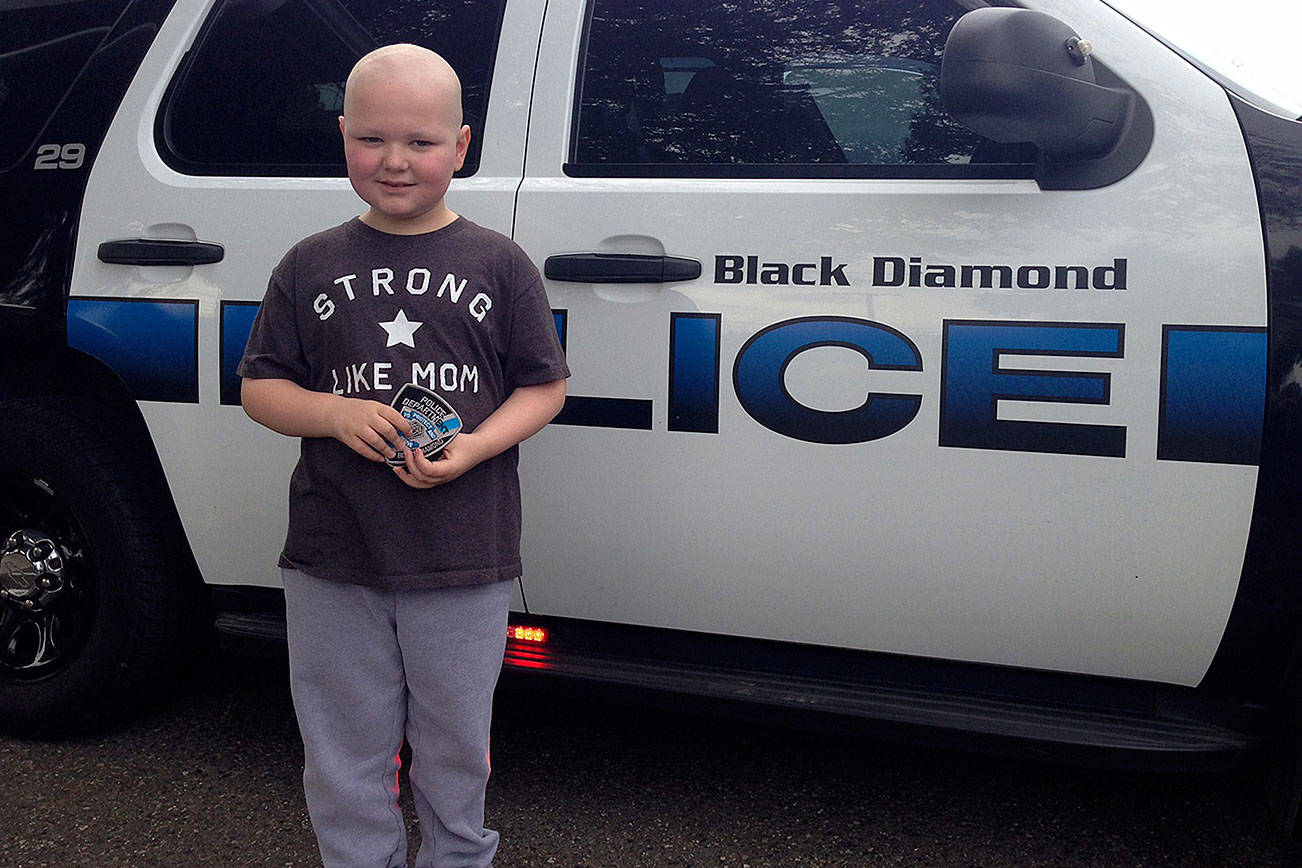 Jack Reich in front of a Black Diamond police car. Submitted photo by Brian Lynch