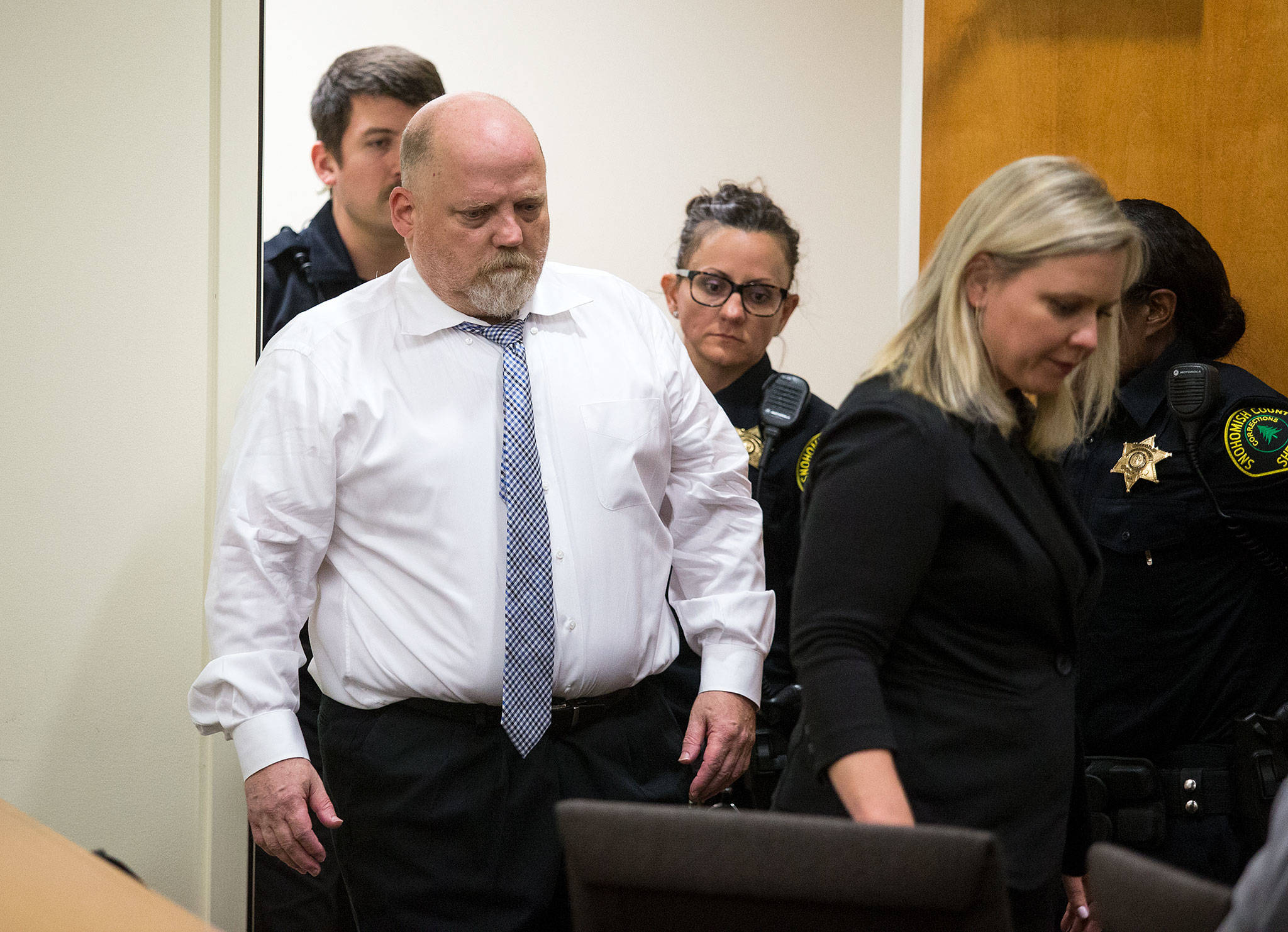 Led by defense attorney Rachel Forde, William Earl Talbott II enters Snohomish County Superior Court on Tuesday in Everett to be arraigned for the 1987 murders of Jay Cook, 20, and Tanya Van Cuylenborg, 18. (Andy Bronson / The Herald)