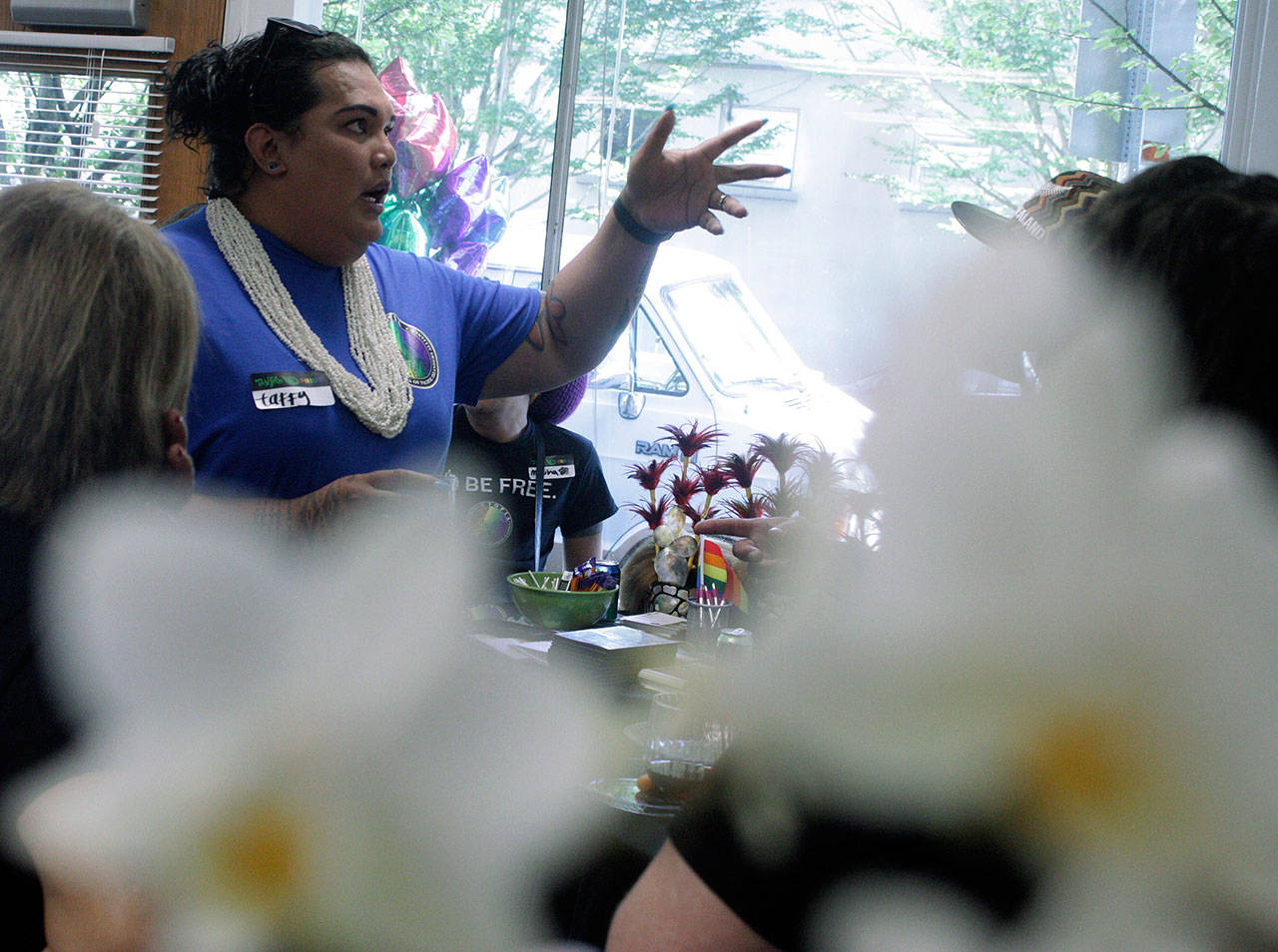 Taffy Johnson, founder and executive director of UTOPIA Seattle (United Territories of Pacific Islanders Alliance), entertains guest at the grand opening of the organization’s downtown Kent center last Saturday. MARK KLAAS, Kent Reporter