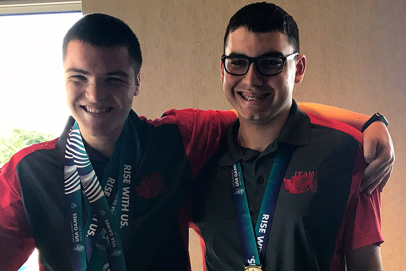Justin Olds and Miguel McCoy from Maple Valley, stand side by side, showing off their gold medals. Photo by Kayse Angel
