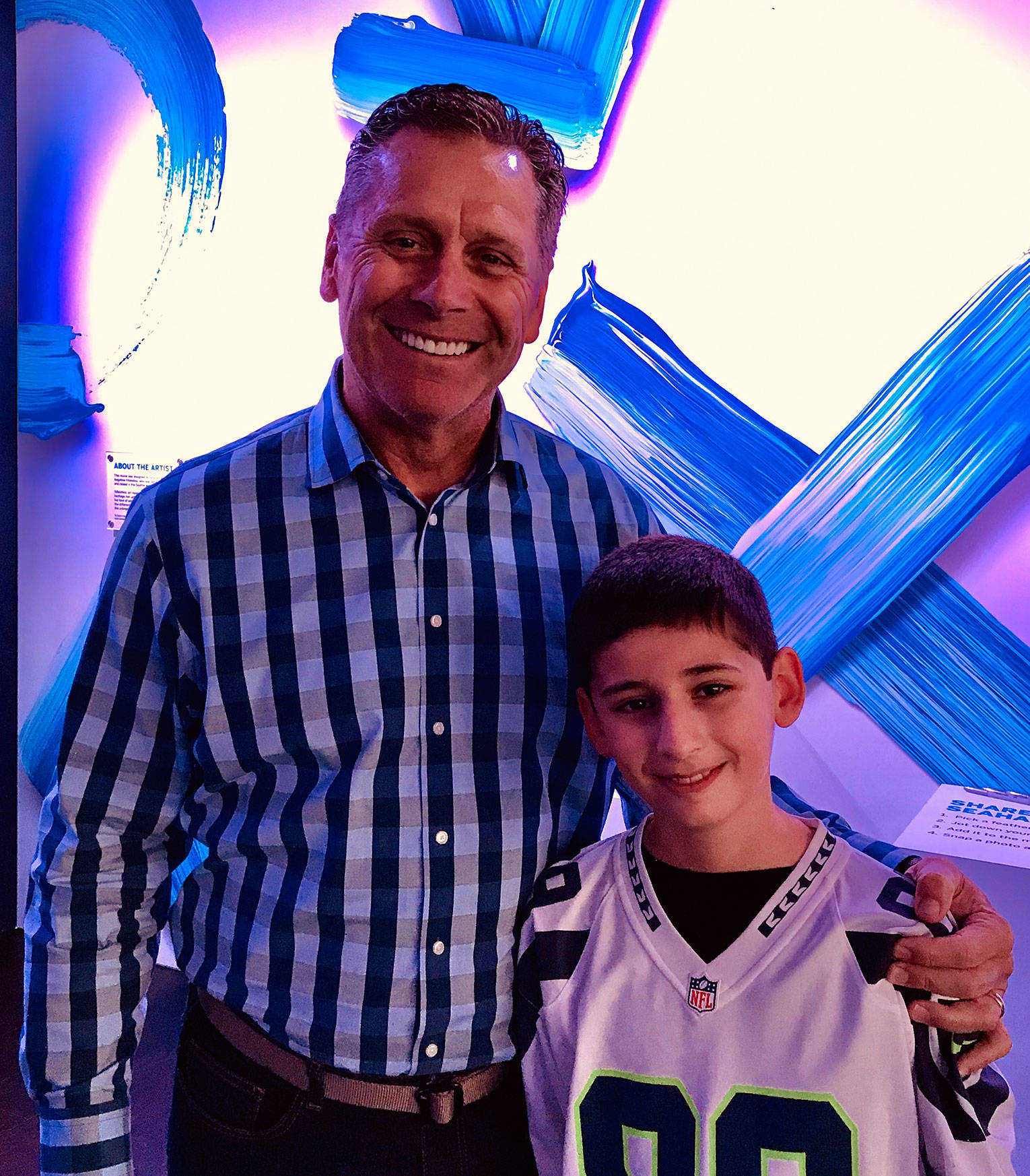 Seattle Seahawks legend Steve Largent shares a moment with a lifelong fan, Logan Kelley, 11, Silverdale. Photo by Eric LaFontaine