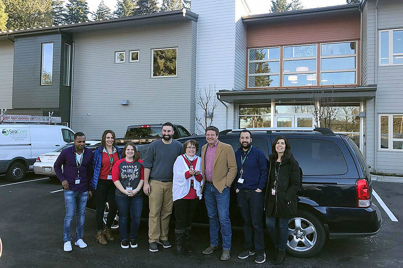 Courtesy photo                                Councilmember Reagan Dunn poses with Vine Maple Place staff members after delivering the keys to a retired Metro van.
