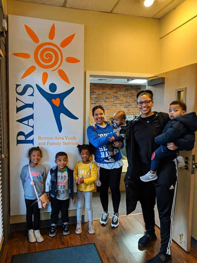 Chastity Fant and Nadia Jackson-Jefferson organized the wish lists and attended a gift wrapping party at RAYS with their children last Friday before the event. Photo courtesy RAYS