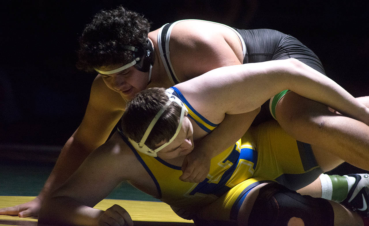 Kentwood’s Victor Juarez, left, delivers a win by fall at 285 pounds.                                Photos by Kayse Angel