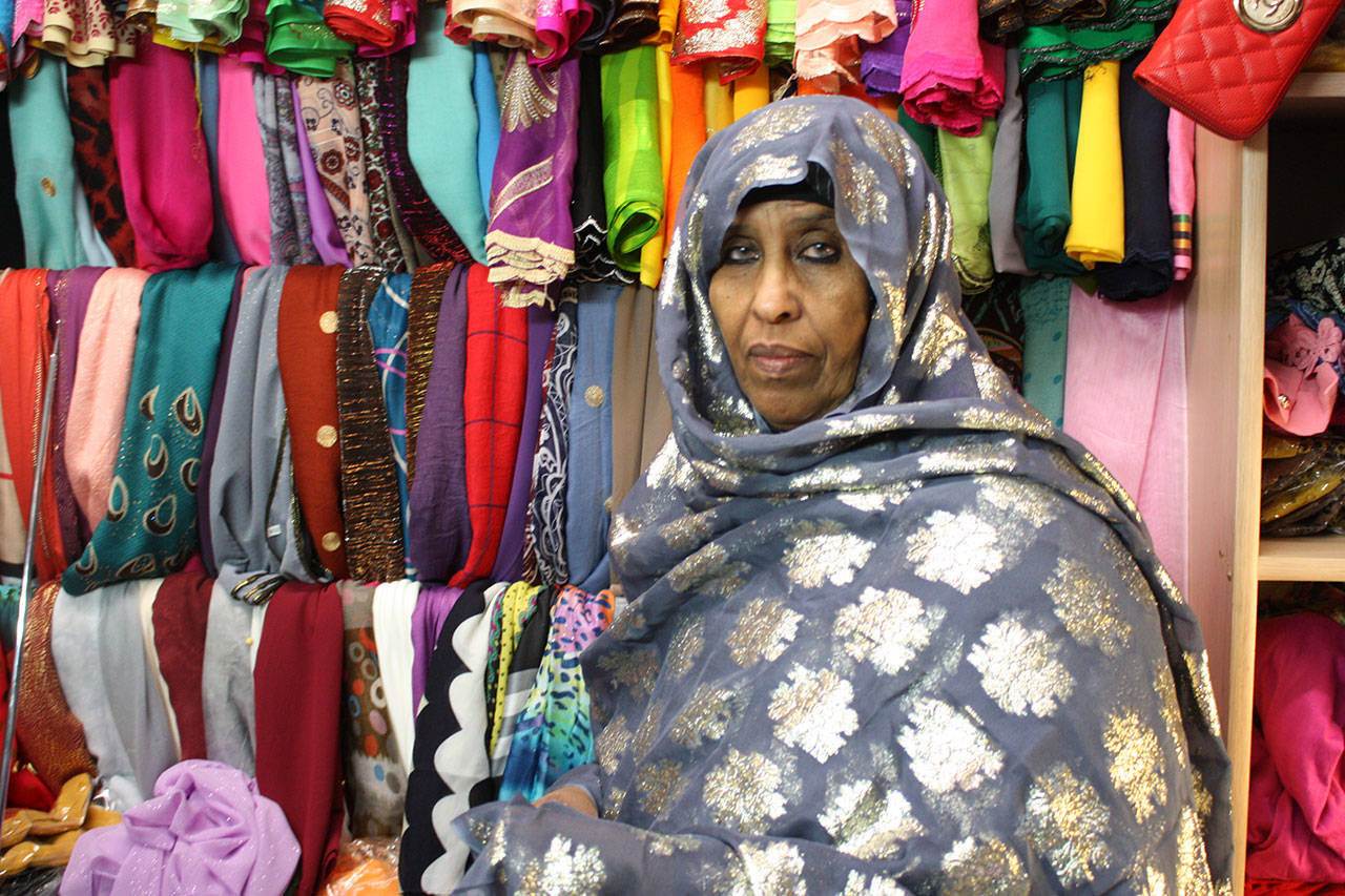 Nadifa Yusef, a Somalian immigrant and SeaTac shop owner, showcases some of her garments. They are traditional Somali dresses called dirac. Aaron Kunkler/staff photo