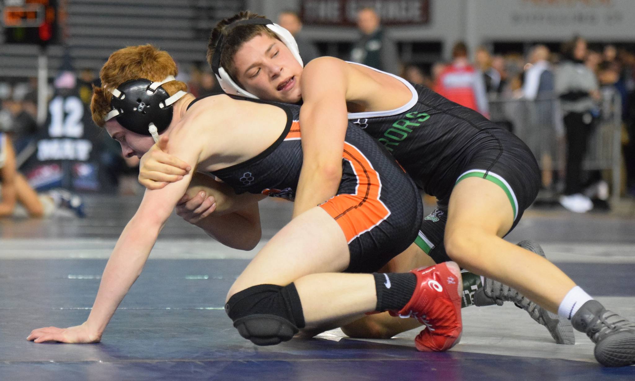 Kentwood’s 113-pound freshman Wylder Kraght, right, takes on Davis’ Dominic Sowers during consolation round action at Mat Classic XXXI. Kraght won by a 7-2 decision. He later wound up sixth in the weight class. RACHEL CIAMPI, Kent Reporter