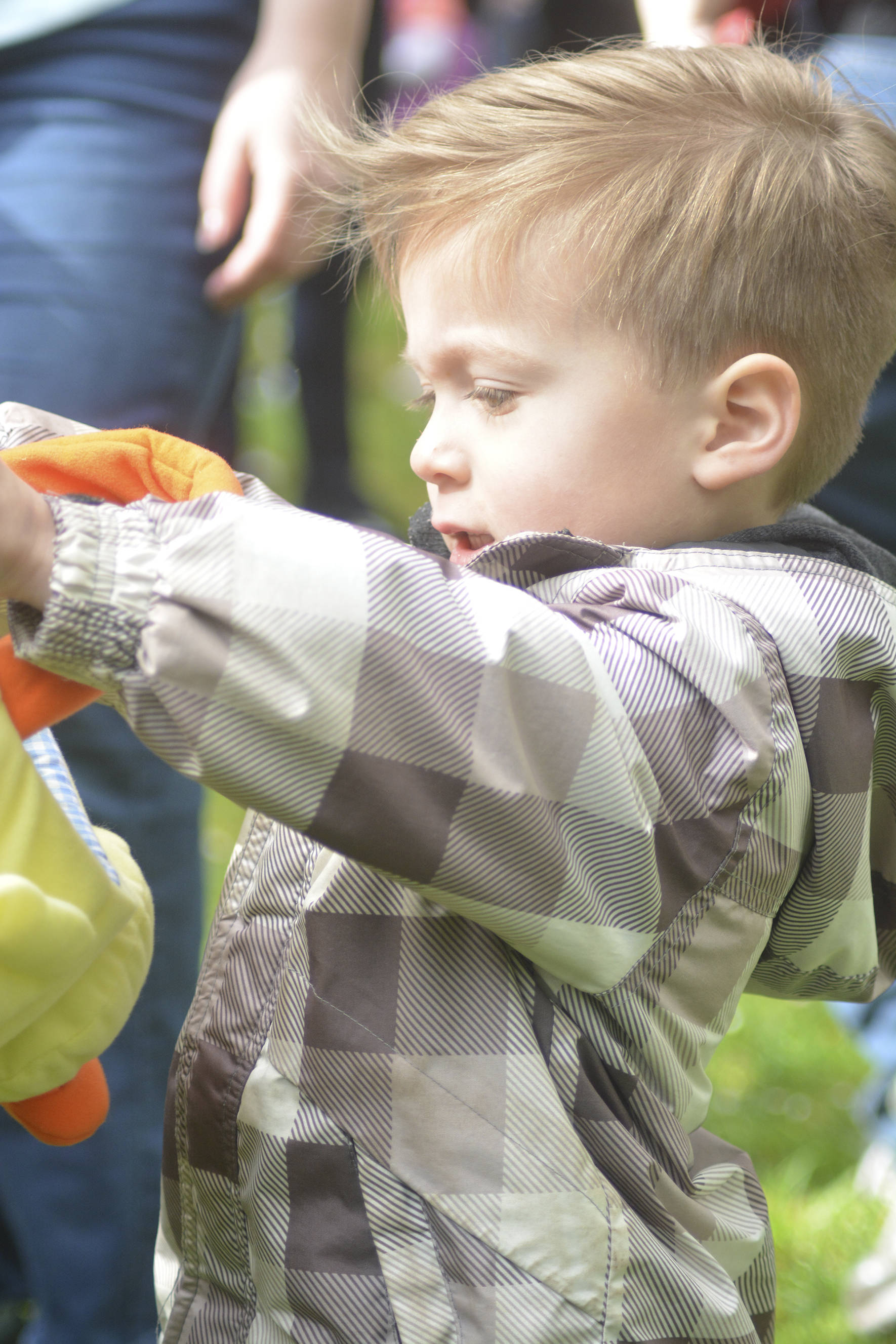 Cameron Hotchkiss explores his Easter basket to see what he found in the Easter egg hunt at Lake Wilderness Park. Photo by Kayse Angel