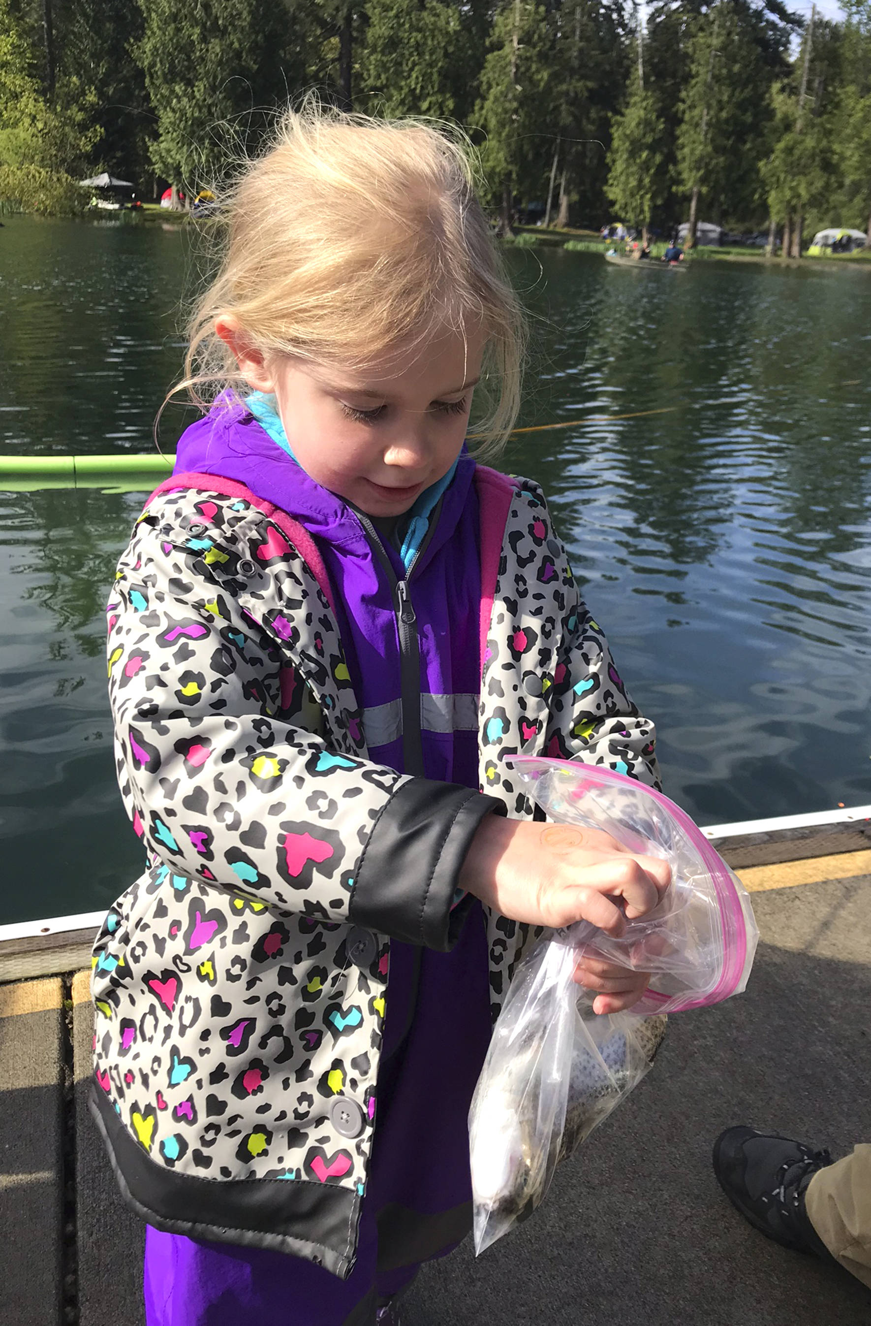 Emily Morgan holds her newly caught fish during the Lake Wilderness Hooked On Fishing Derby. Photo by Kayse Angel