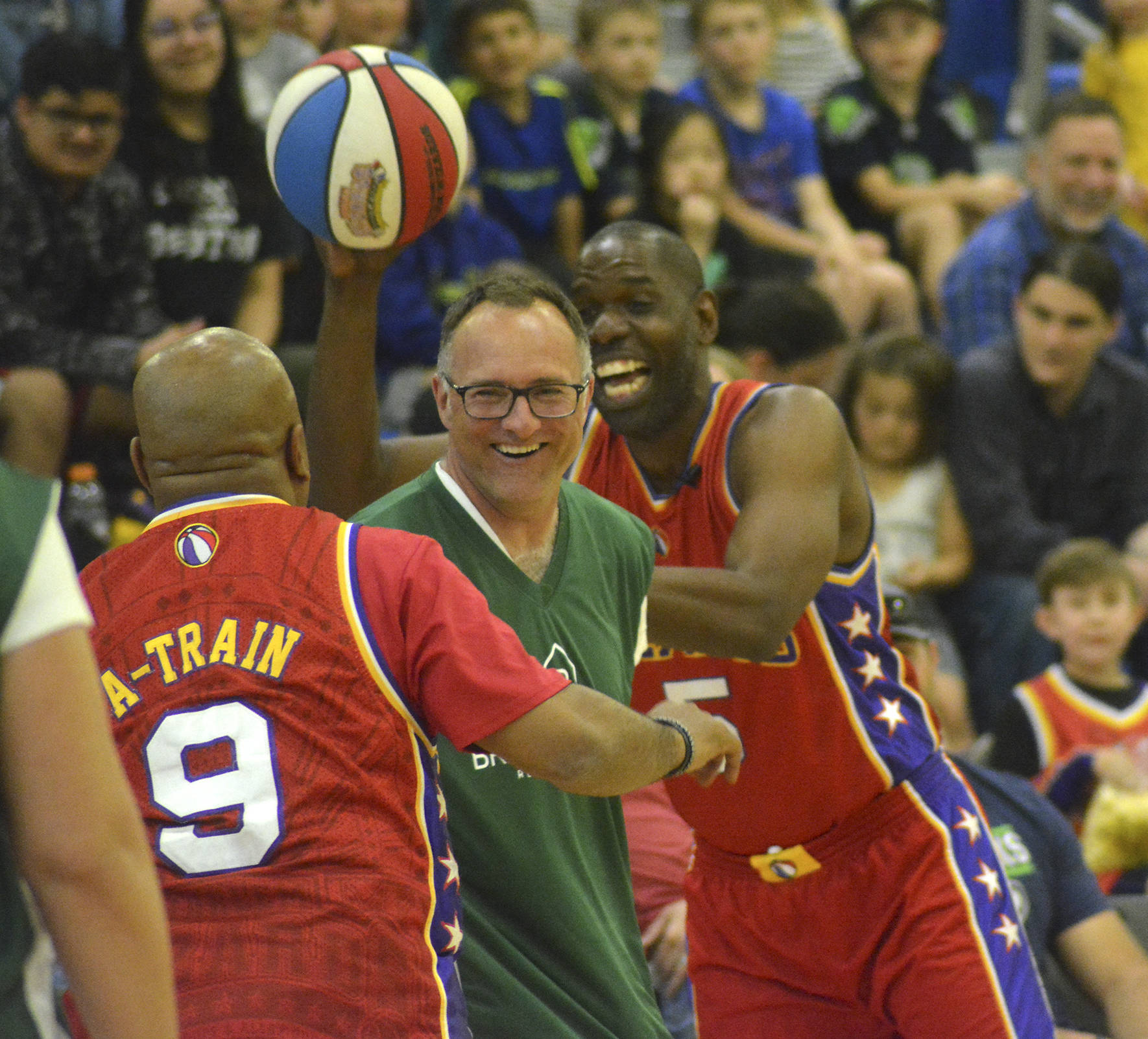 Two Harlem Wizards play keep away with the ball from one of the Tahoma staff members during the fundraising event that took place on May 3 at Tahoma High School. Photo by Kayse Angel