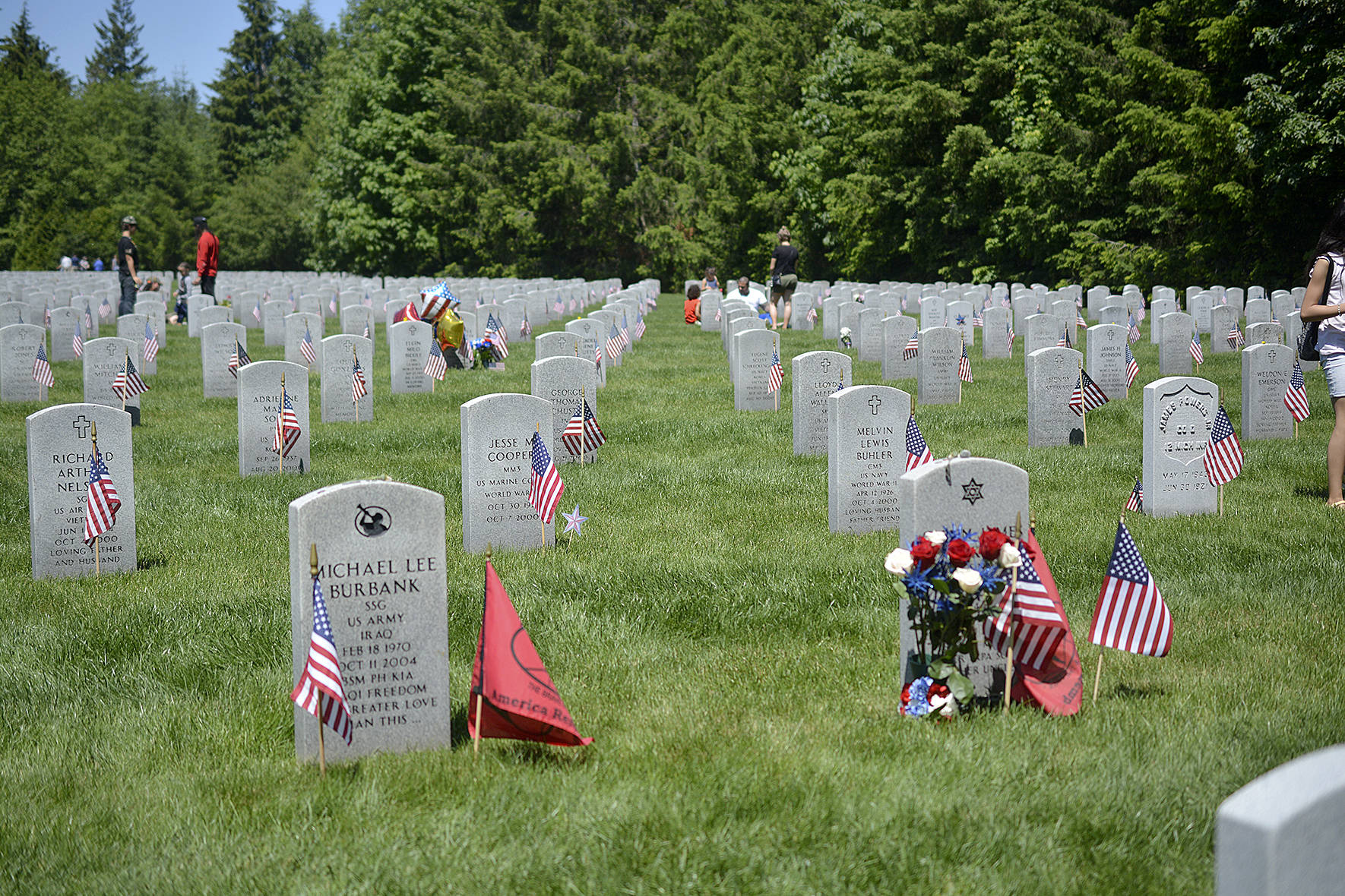 Photos by Kayse Angel                                 Grave stones with flags and flowers at the Tahoma National Cemetery on May 27.