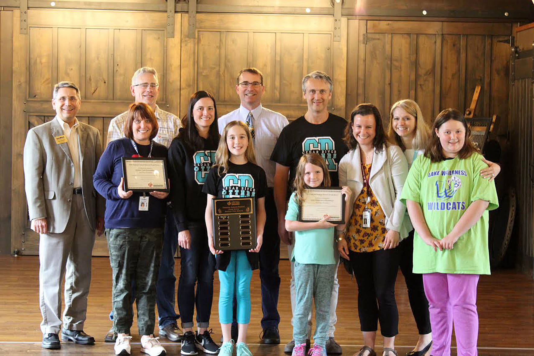 Photo courtesy of Cedar River Elementary.                                 Cedar River students and staff stand together after receiving the Golden Can award.