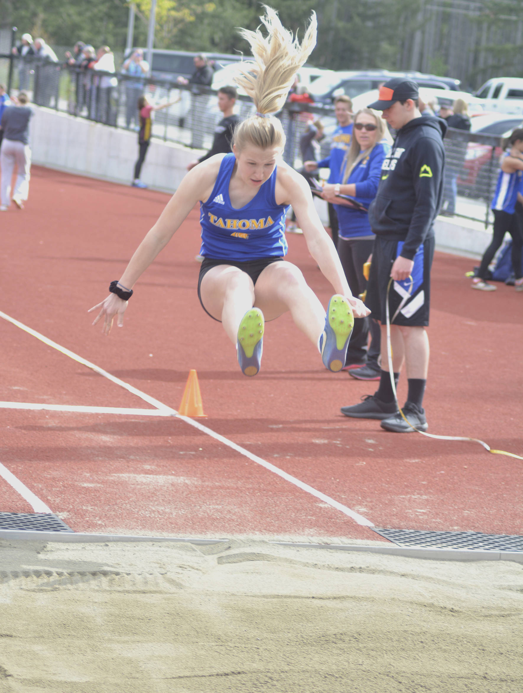 Tahoma track student Katie Welsh leaps into the sand during the long jump. File photo by Kayse Angel